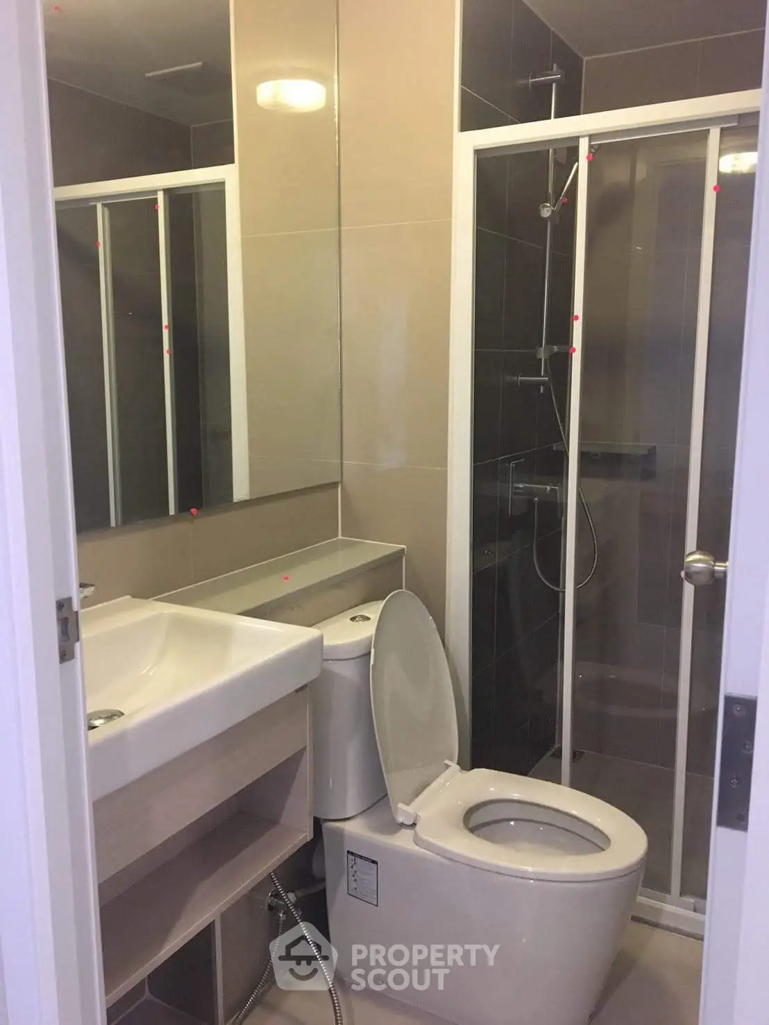 Modern bathroom with glass shower and sleek fixtures in a contemporary apartment.