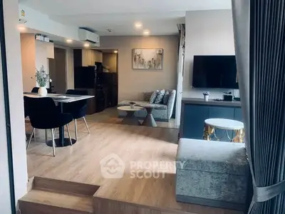 Modern living room with stylish decor and open layout, featuring a cozy seating area and elegant dining space.
