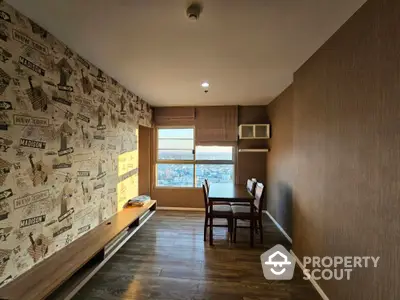 Cozy study room with a travel-themed wallpaper and a scenic city view through the large window, complemented by wooden flooring and built-in shelves.