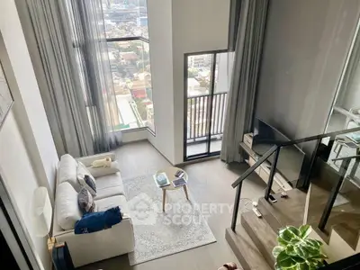 Stunning high-rise living room with floor-to-ceiling windows and city view, featuring modern decor and cozy ambiance.