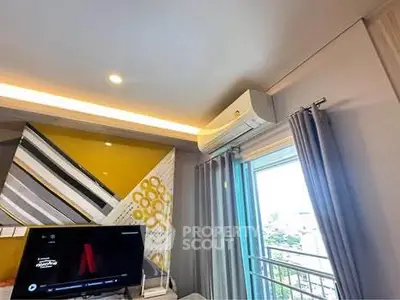 Modern living room with stylish decor and air conditioning, featuring a balcony view.