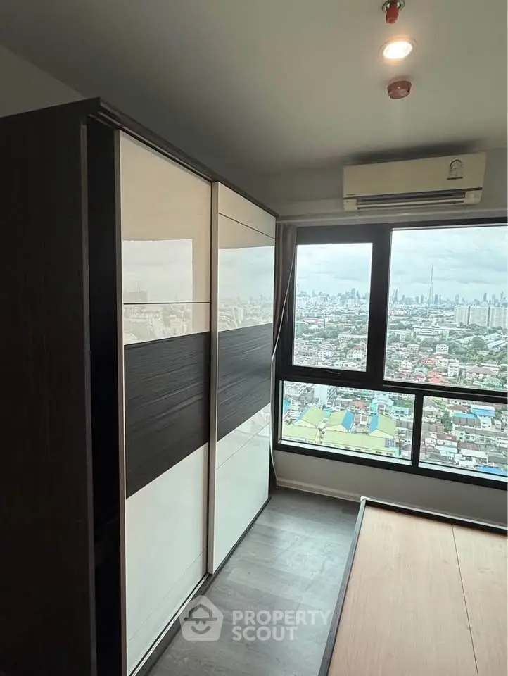Modern bedroom with city view and sleek wardrobe design