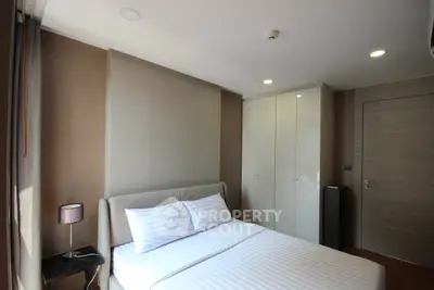 Modern bedroom with stylish decor and ample natural light
