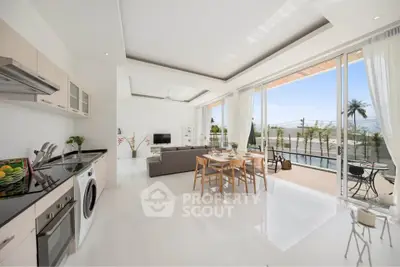 Spacious open-plan living room with modern kitchen and pool view