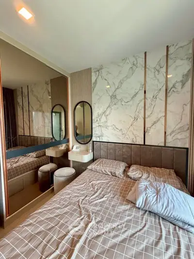 Luxurious bedroom with elegant marble accent wall and stylish mirrored wardrobe
