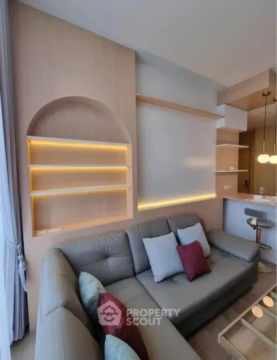 Modern living room with stylish shelving and cozy sectional sofa in elegant apartment.