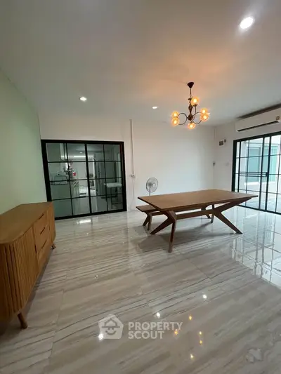 Spacious modern living room with elegant chandelier and stylish furniture