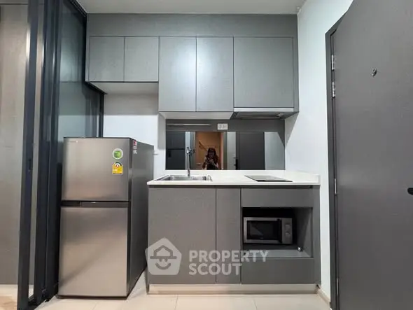 Modern compact kitchen with sleek cabinets and stainless steel appliances