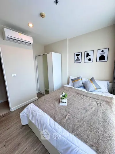 Modern bedroom with stylish decor and air conditioning in a cozy apartment.