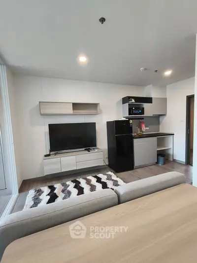 Modern living room with sleek furniture and open kitchen layout