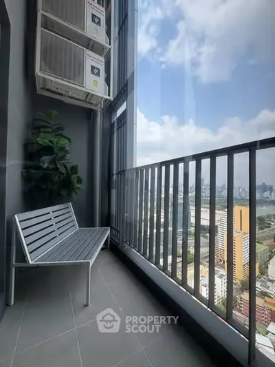 Stunning high-rise balcony with cityscape view and modern seating area.