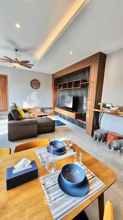 Modern living room with stylish wooden accents and cozy dining area