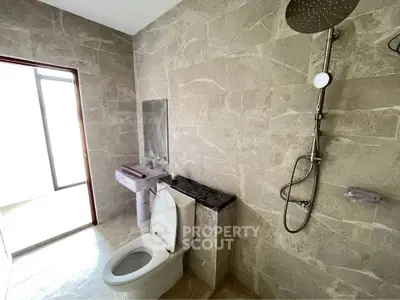 Modern bathroom with elegant stone tiles and rainfall showerhead