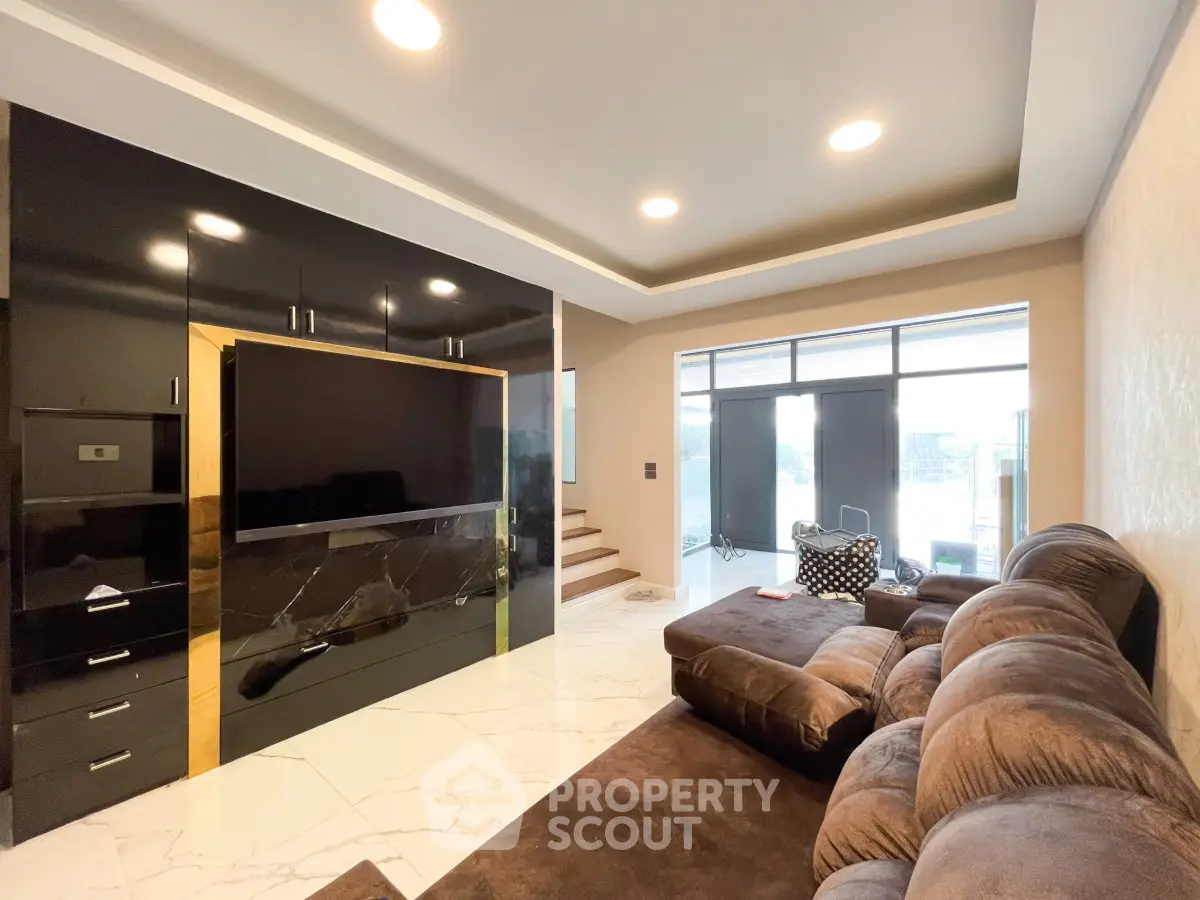 Luxurious living room with plush seating and modern entertainment center