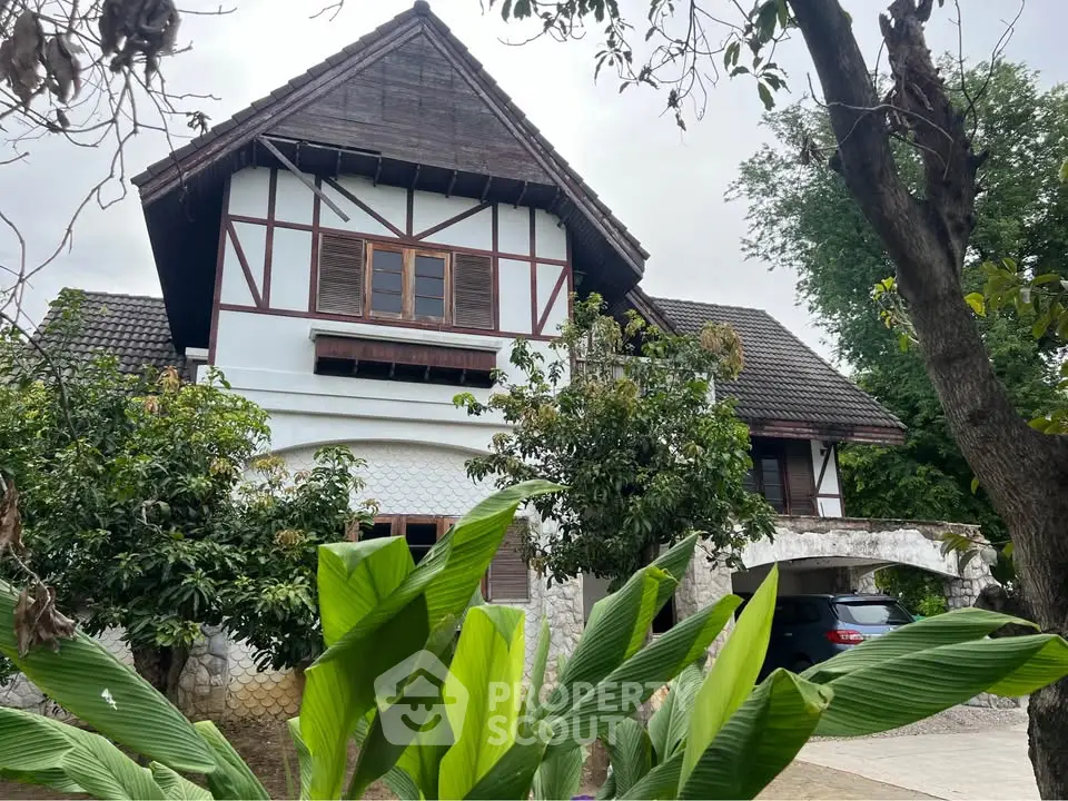 Charming rustic house with lush greenery and unique architectural design