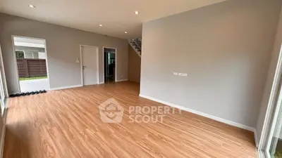 Spacious empty living room with wooden flooring and modern design