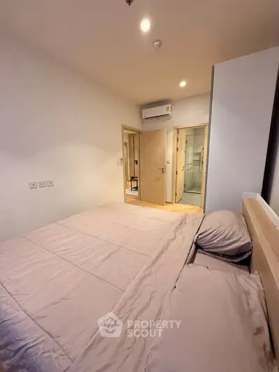 Cozy bedroom with modern air conditioning and ensuite bathroom, perfect for comfortable living.