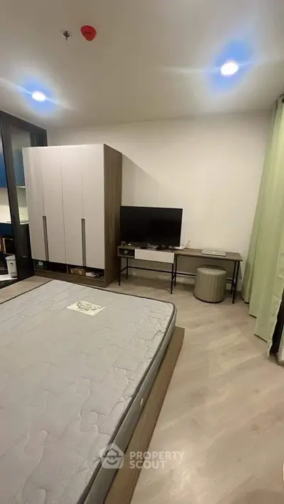 Modern bedroom with minimalist decor and large wardrobe