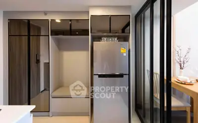 Modern kitchen with sleek fridge and dining area in stylish apartment