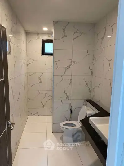Modern bathroom with marble tiles and sleek fixtures