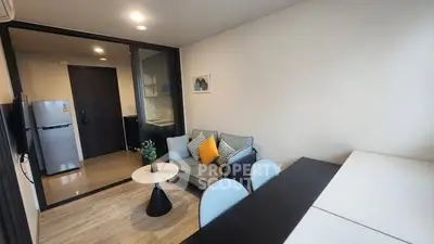 Modern living room with cozy seating and dining area, featuring sleek design and natural lighting.