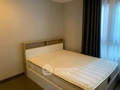 Cozy bedroom with modern bed and soft lighting, perfect for relaxation.