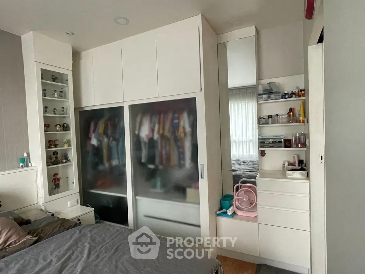 Modern bedroom with sleek wardrobe and organized storage solutions