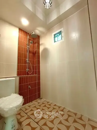 Modern bathroom with stylish tiles and a sleek shower design.