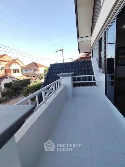Spacious balcony with tiled flooring and neighborhood view in modern home