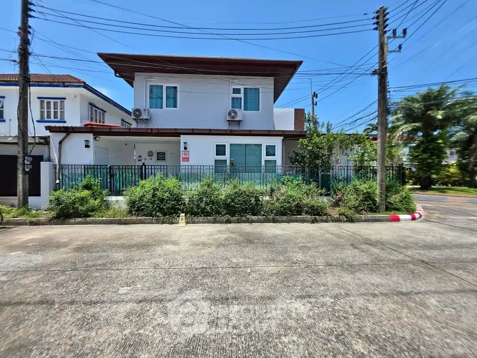 Modern two-story house with lush greenery and spacious driveway in a serene neighborhood.