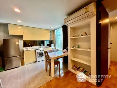 Modern kitchen with dining area and built-in appliances in stylish apartment