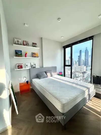 Modern bedroom with city view, featuring sleek design and natural light.