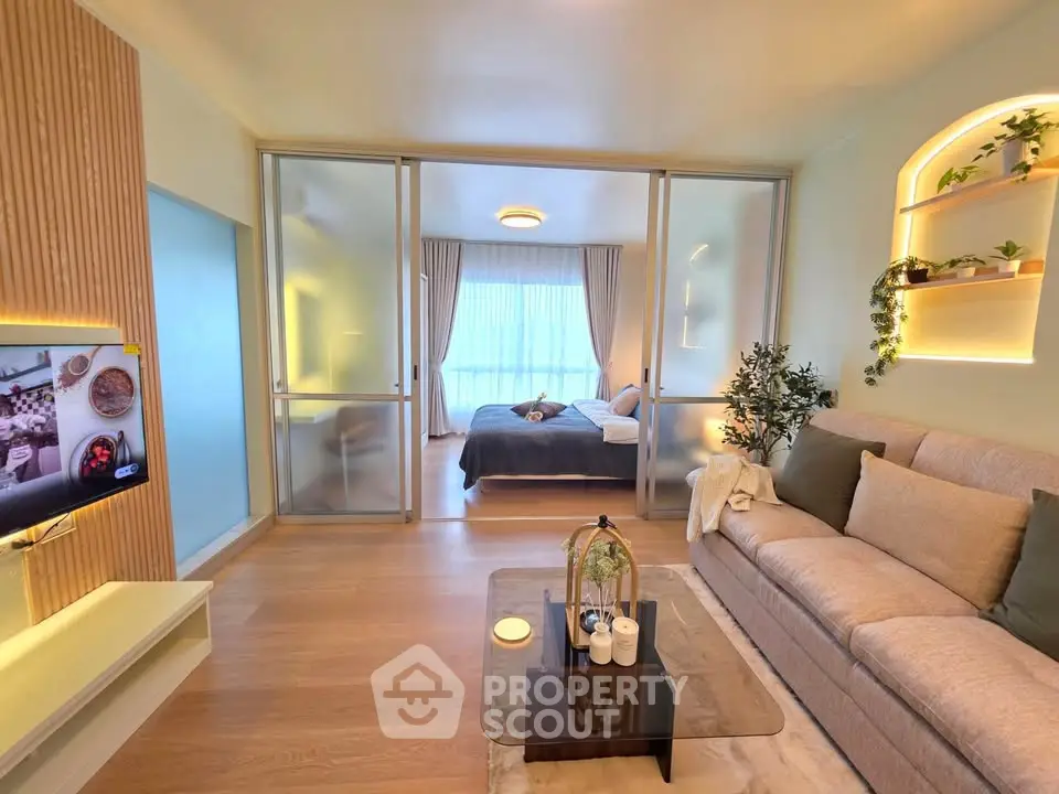 Modern living room with glass partition and cozy bedroom view