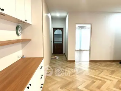 Spacious modern interior with wooden flooring and built-in storage, perfect for stylish living.