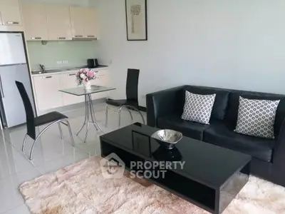Modern living room with sleek kitchen and stylish decor