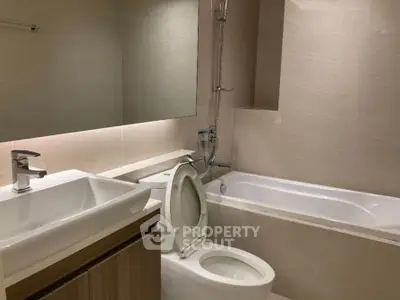Modern bathroom with sleek fixtures and bathtub in a contemporary apartment.