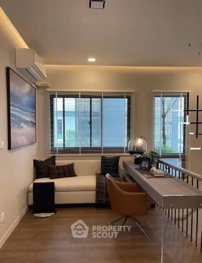 Modern living room with stylish decor and large windows offering natural light.