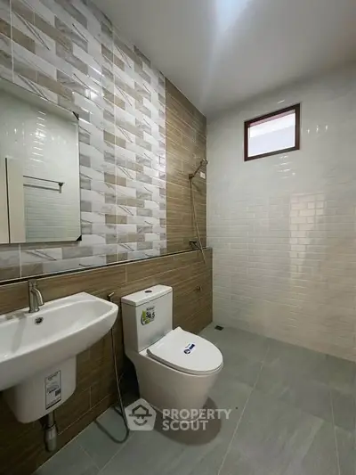 Modern bathroom with stylish tiles and sleek fixtures in a contemporary home.