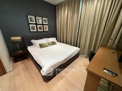 Modern bedroom with stylish decor and natural light, featuring a comfortable bed and elegant furnishings.
