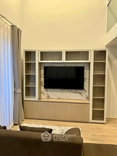 Modern living room with built-in TV unit and elegant curtains