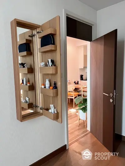 Modern interior with open wooden cabinet and view into dining area