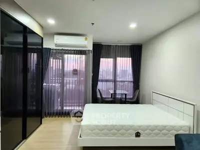 Modern bedroom with large window and minimalist design