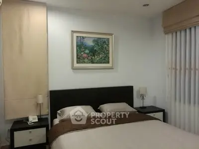 Cozy bedroom with elegant decor and soft lighting, featuring a comfortable bed and stylish bedside tables.