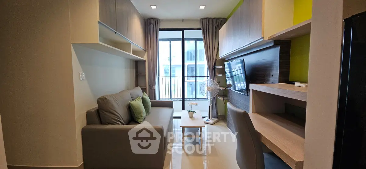 Modern living room with sleek furniture and balcony view in a stylish apartment.