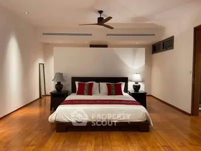 Spacious bedroom with elegant wooden flooring and modern decor