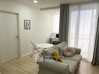 Cozy living room with modern decor and balcony access