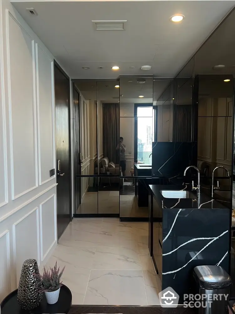 Luxurious modern bathroom with sleek black marble sink and mirrored walls