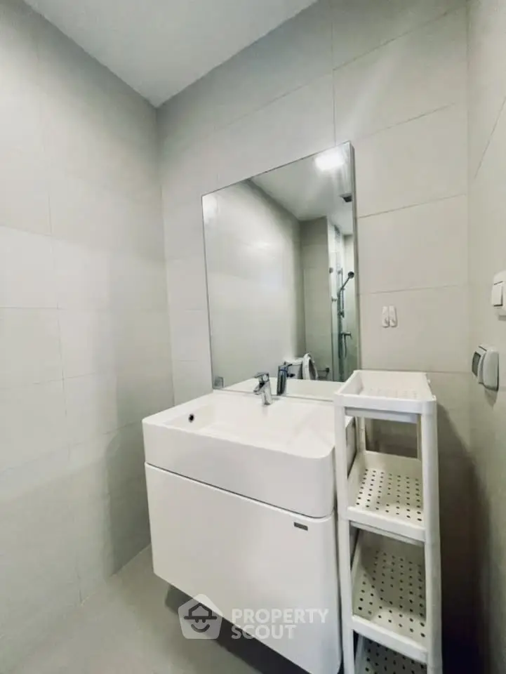 Modern bathroom with sleek white vanity and large mirror