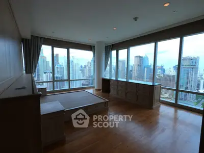 Spacious corner unit with panoramic city views and elegant wooden flooring.