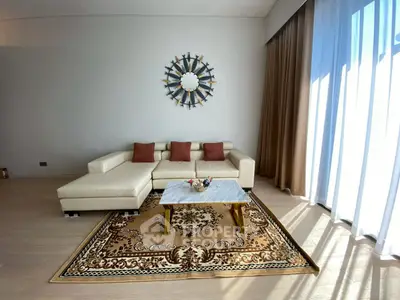 Elegant living room with modern sofa, stylish decor, and natural light